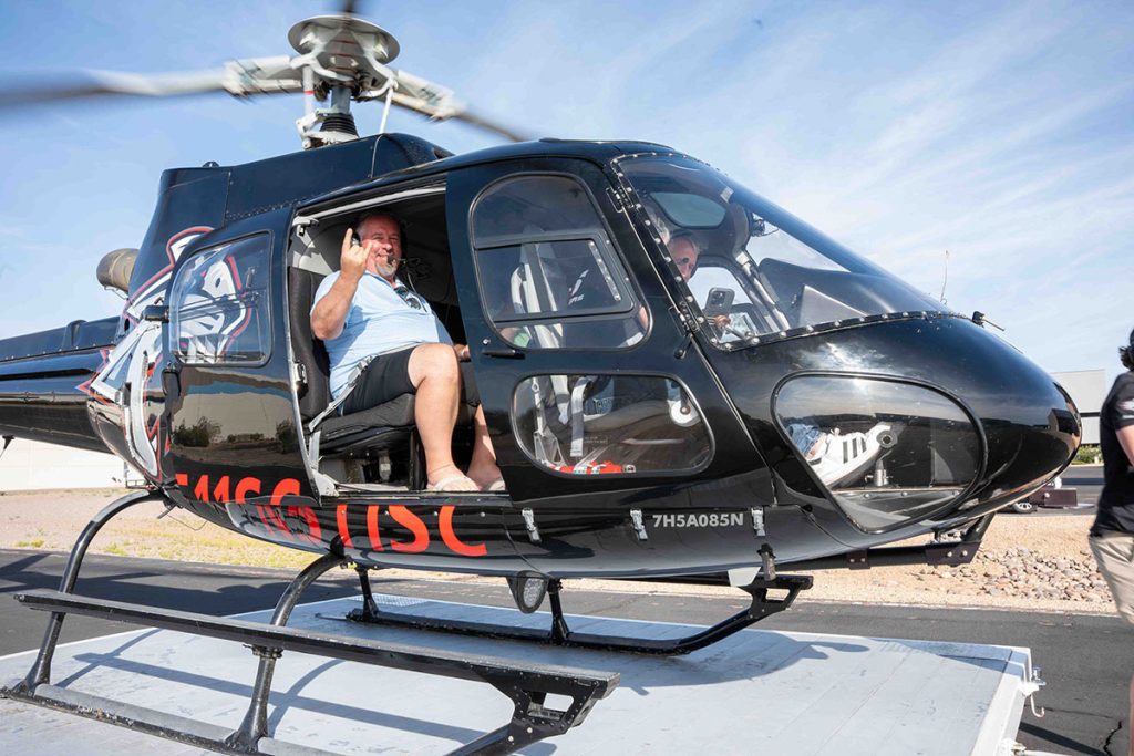 man in helicopter on group outing