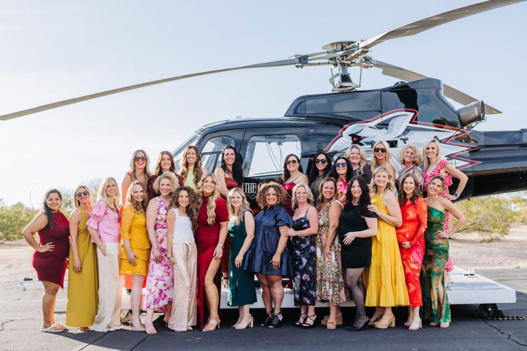 group event in front of a helicopter