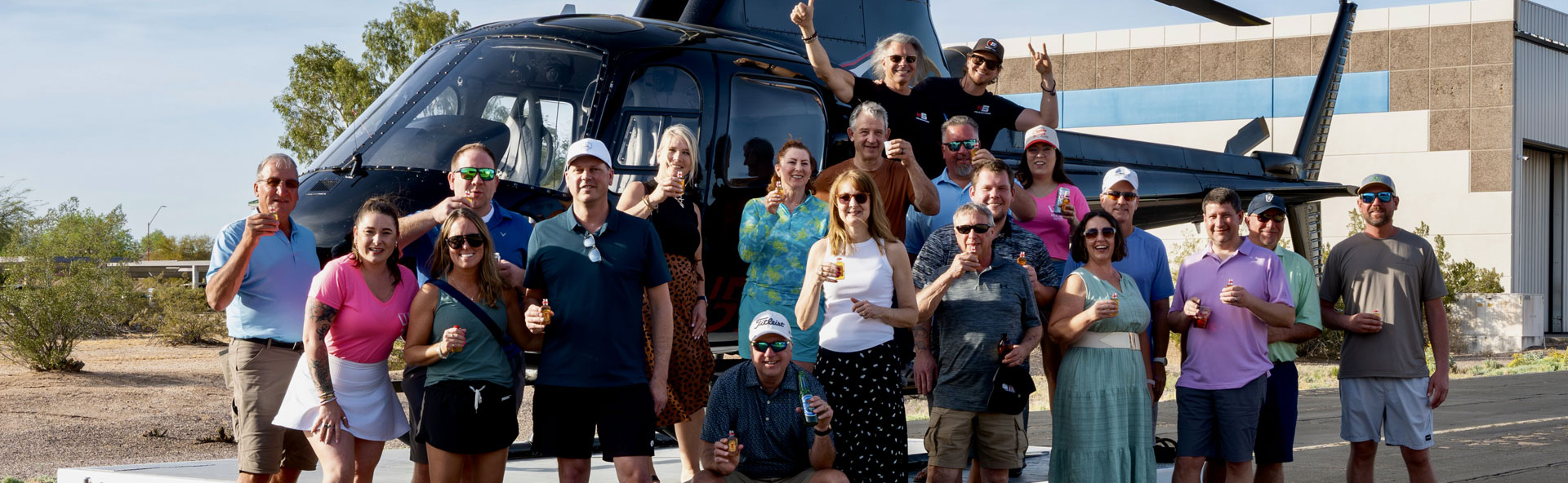 group event in front of a helicopter